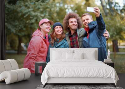 Holidays with friends. Group of young people taking selfie together in the park. Wall mural