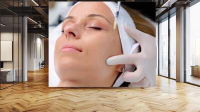 Medical cosmetology treatments. Young woman receiving botox injection at beauty clinic, closeup. Wall mural