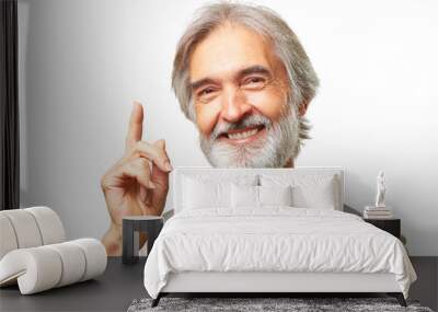 Portrait of handsome senior caucasian man with gray beard and bowtie has an idea pointing finger up isolated on white background Wall mural