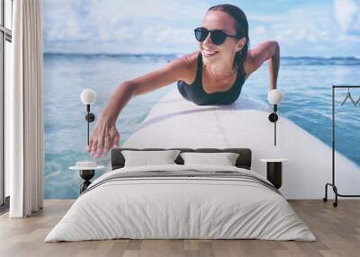 Summer Adventure. Water Sports. Happy Carefree Sexy Woman Surfing, Lying On Paddle, Surf Board In Sea Clear Water. Holidays Travel Vacation. Healthy Active Lifestyle. Leisure Activity. Wall mural