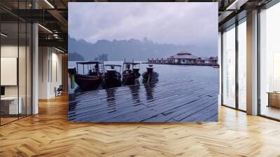 Traditional wooden boats on wharf in Cheow Lan Lake, Khao sok national park, Thailand. Wall mural