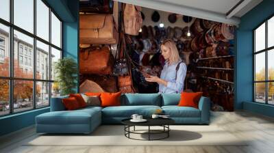 Travel and shopping. Young traveling woman with choose presents in bag shop in Morocco. Wall mural