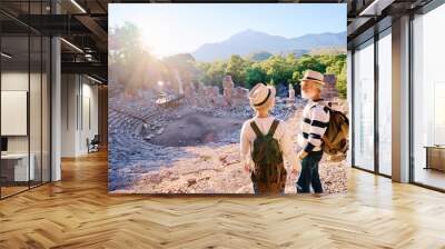 Travel and tourism. Senior family couple enjoying view together on ancient amphitheatre. Wall mural