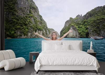 Traveling by Thailand. Pretty young woman enjoying view sailing on the yacht by Phi Leh lagoon. Wall mural