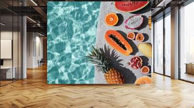 Vacation and diet concept. Tropical exotic colorful fruits near water in swimming pool. Wall mural