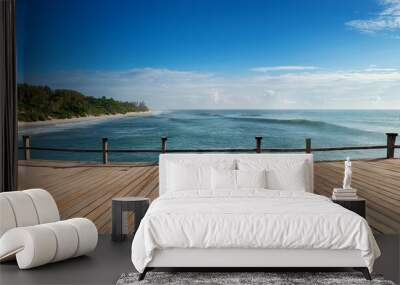 A wooden deck with a view of the ocean Wall mural