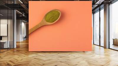 Organic green powder in wooden spoon - Moringa Wall mural