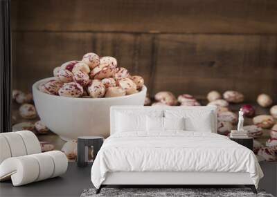 Raw pinto beans in bowl on wooden table Wall mural