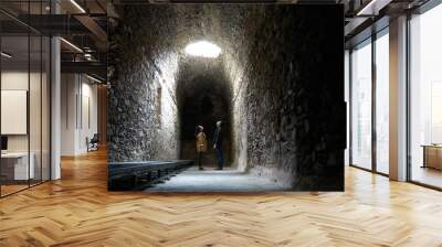 Romantic couple on a dark ruin antique temple arab muslim church tunnel room with a hole where light comes through Wall mural