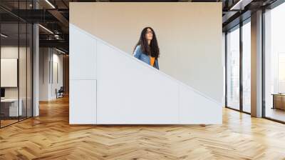 Transgender woman walking down a modern staircase Wall mural