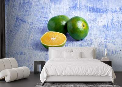 fresh and juicy green mandarins on a blue background. healthy food concept Wall mural