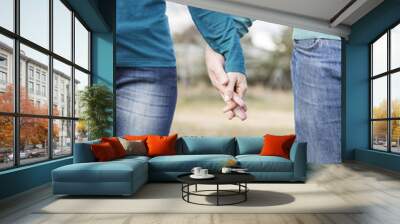 the hands of a woman and a man entwined as a happy couple
 Wall mural