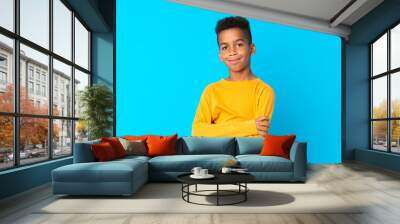 African American boy over isolated blue background smiling a lot Wall mural