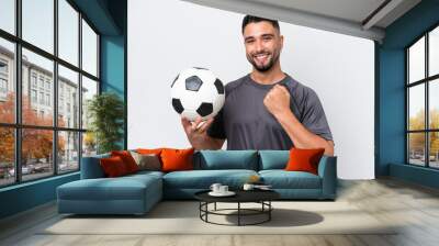 Arab young football player man isolated on white background celebrating a victory Wall mural