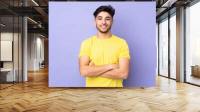 Arabian handsome man over isolated background with arms crossed and looking forward Wall mural