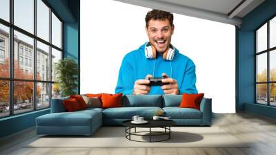 Brazilian man playing with a video game controller over isolated chroma key background Wall mural