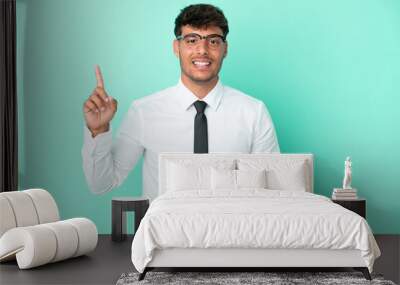 Business caucasian man isolated on blue background showing and lifting a finger in sign of the best Wall mural