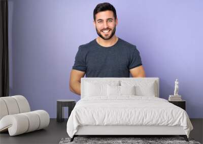 Caucasian handsome man laughing over isolated purple background Wall mural