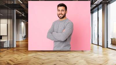 Caucasian handsome man over isolated background with arms crossed and looking forward Wall mural