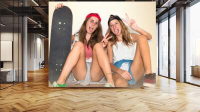 Friends with their skateboards doing victory gesture Wall mural