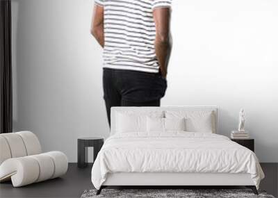 Full body of Dark skinned man with striped shirt looking back on white background Wall mural