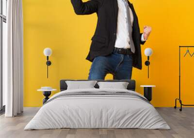 Full-length shot of business man over isolated yellow background Wall mural