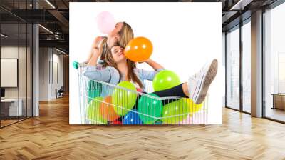 girl with many balloons inside supermarket cart Wall mural