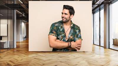 Handsome man in summer shirt over isolated background looking to the side Wall mural