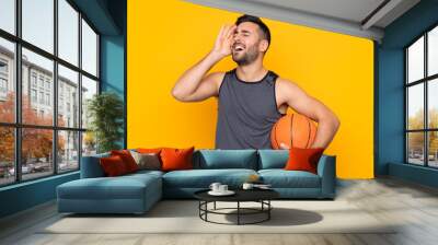 Handsome young basketball player man over isolated white wall has realized something and intending the solution Wall mural