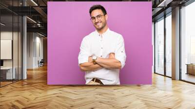 Handsome young man over isolated background with glasses and happy Wall mural