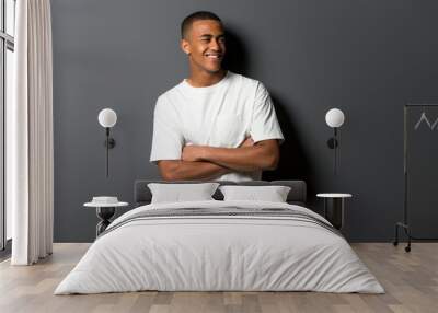 Happy young african american man on grey wall background Wall mural