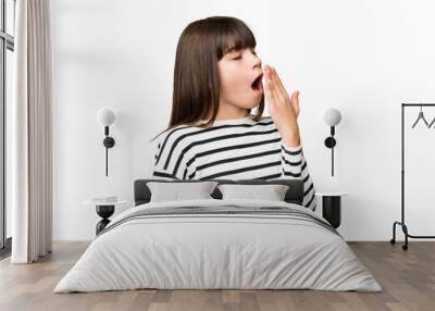 Little caucasian girl over isolated background yawning and covering wide open mouth with hand Wall mural