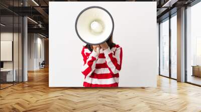 Little girl isolated on white background shouting through a megaphone to announce something Wall mural