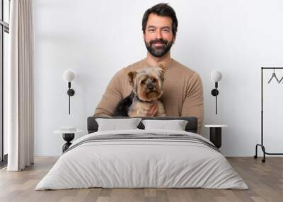 Man holding a yorkshire isolated on white background smiling a lot Wall mural