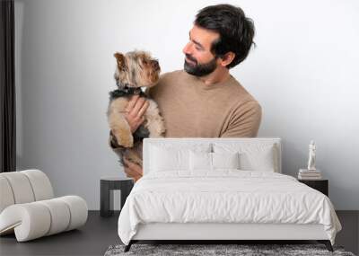 Man holding a yorkshire isolated on white background with happy expression Wall mural