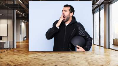 Man with a motorcycle helmet over isolated background yawning and covering wide open mouth with hand Wall mural