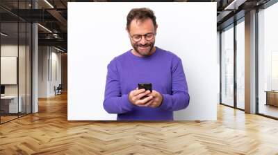 Middle age caucasian man isolated on white background sending a message with the mobile Wall mural