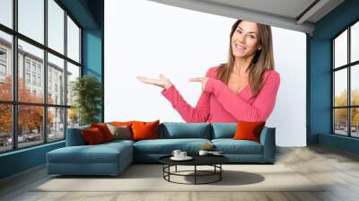 Middle age caucasian woman isolated on white background holding copyspace imaginary on the palm to insert an ad Wall mural