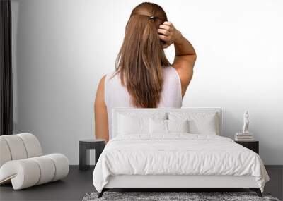 Middle age woman over isolated background in back position and thinking Wall mural