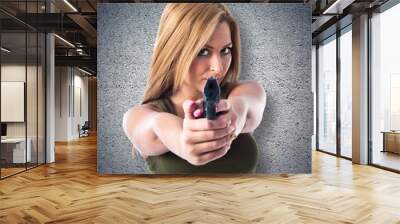 Military woman aiming a gun Wall mural