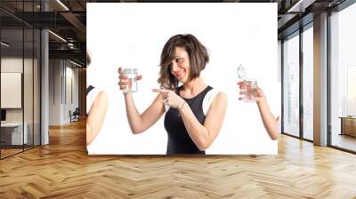 Pretty girl holding an empty bottle of glass over white backgrou Wall mural