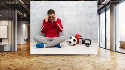 Redhead sport man with glasses and surprised Wall mural