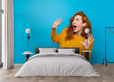 Redhead woman with yellow sweater nervous and scared Wall mural