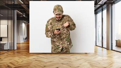 Soldier man isolated on white background surprised and sending a message Wall mural