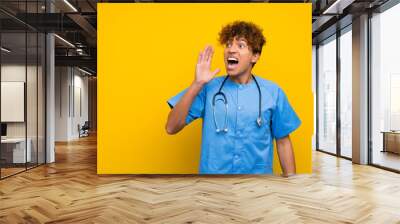 Surgeon doctor african american man shouting with mouth wide open Wall mural