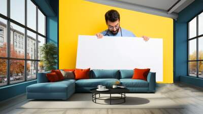 Surgeon doctor man holding an empty white placard Wall mural