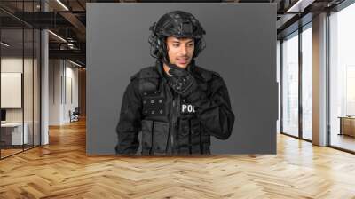 SWAT caucasian man isolated on grey background looking to the side Wall mural