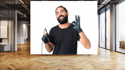 Tattoo artist caucasian man over isolated chroma key background showing ok sign with fingers Wall mural