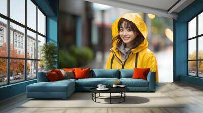 Teen pretty Japanese girl at outdoors wearing a rainproof coat Wall mural