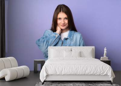 Teenager caucasian girl isolated on purple background laughing Wall mural